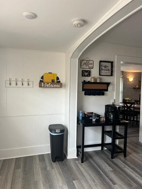 The kitchen has a place to hang coats and a coffee station.