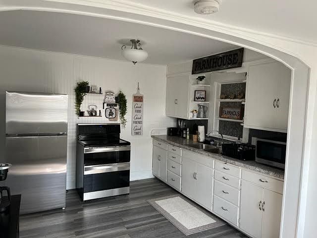 A full-size refrigerator and double stove