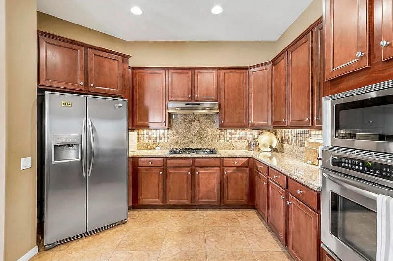 kitchen with fridge, stove, microwave and oven
