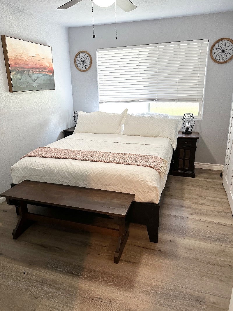2nd bedroom with queen size bed, ceiling fan, nightstands, closet, and smart TV.