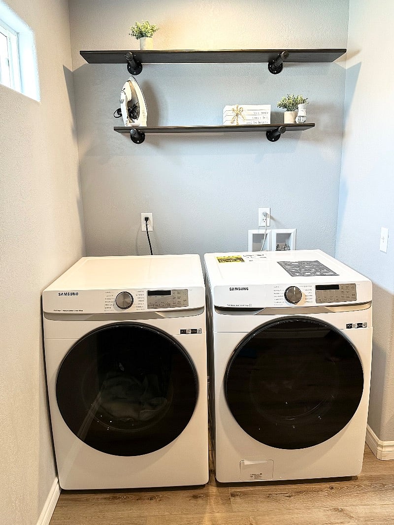 Mud / laundry room with full size washer and dryer, storage pantry for linens and cleaning supplies. 1/2 bath resides between mud / laundry room and kitchen.