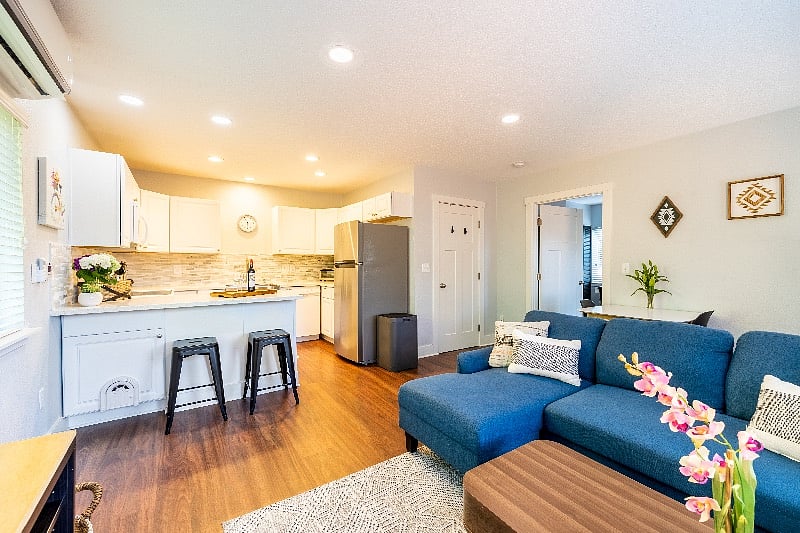 Full kitchen with breakfast bar, electric stove, microwave, sink, dishwasher and refrigerator.