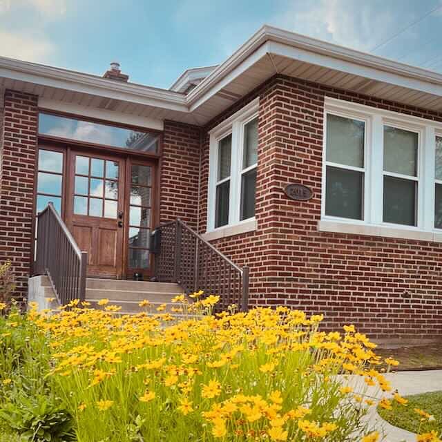 Front of house. View showing railings and ADA compliant stairs.