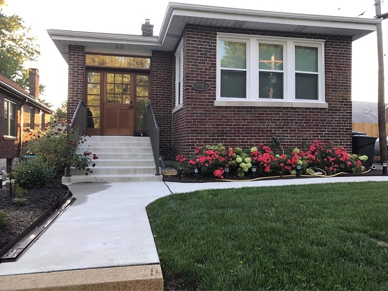 From of house showing railings and ADA compliant stairs.