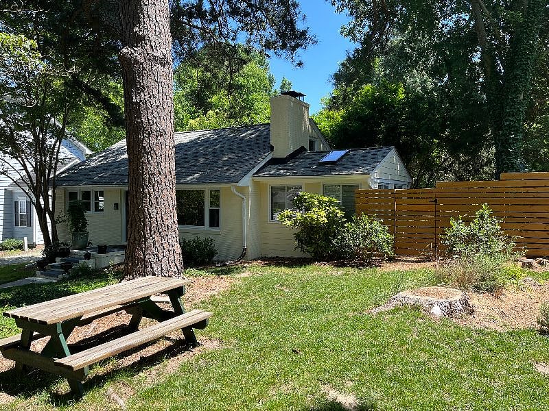Picnic table in front yard under long leaf pine