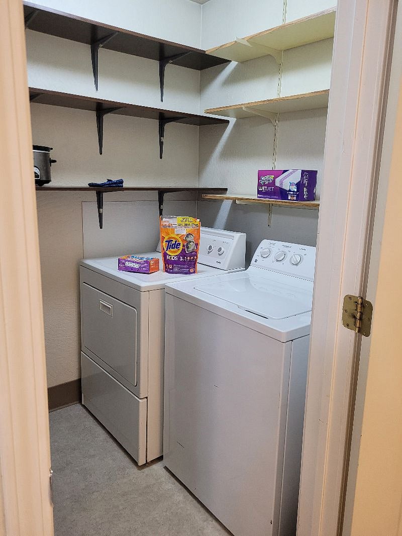 Full-size washer and dryer, full-size ironing board and iron.