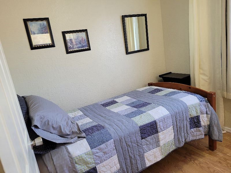 Middle bedroom with twin bed and view of Chugach Mountains.