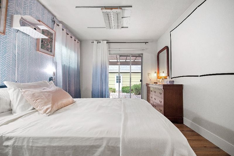 Main floor bedroom with projector TV