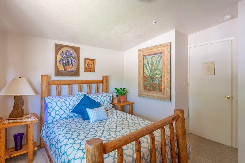 The west bedroom has a new full-sized cute log bed, closet, chair and dresser/amoire with a big, shady cottonwood tree outside.
