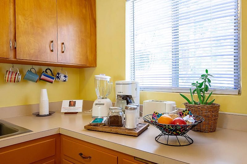 The kitchen is fully furnished with a coffee pot, French press, mugs, dishes, glasses, silverware, pots and pans and more.