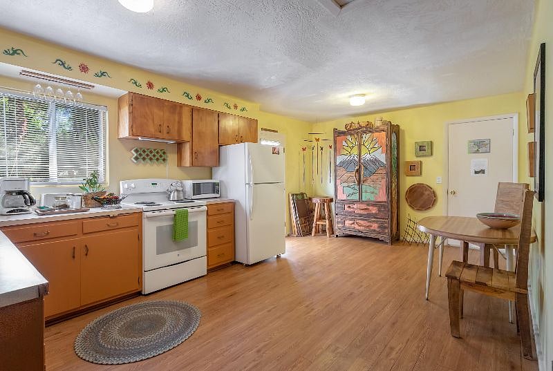 Our bright and spacious kitchen fills with sunlight! Plenty of room for dining inside or out on the adjacent patio and garden. 