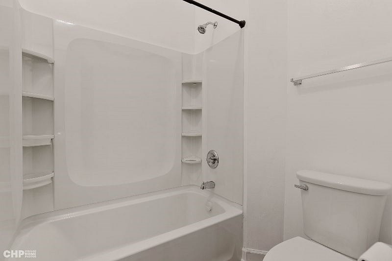 2nd bedroom's bathroom with a bathtub