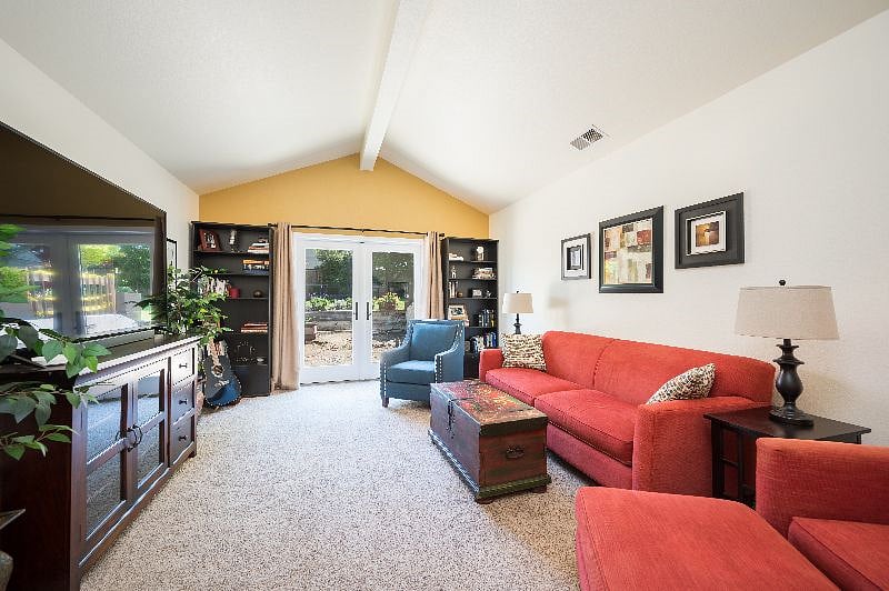 Downstairs den with smart TV, lots of comfy seating, sliders to back yard