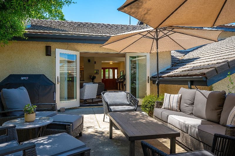 Main floor doors open to backyard to create indoor-outdoor drama.
