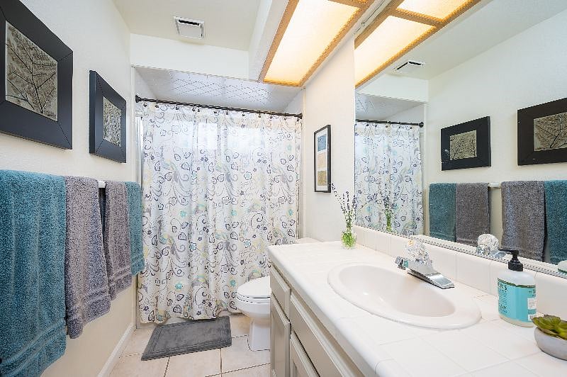 Downstairs bathroom has tile floor, tub/shower and lots of counter space.