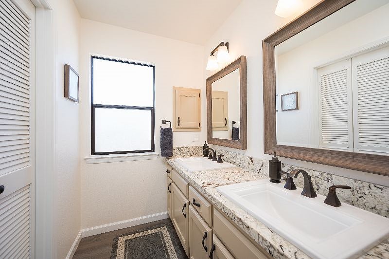 Upstairs en suite bathroom is recently remodeled and laid out as three separate areas (Vanity, Toilet/Shower, Soaking Tub). Double sink vanity area with lots of countertop space opens to walk in closet.