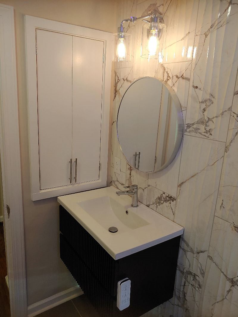 Primary bath vanity and storage. Hair dryer, first aid kit and basic toiletries included. 