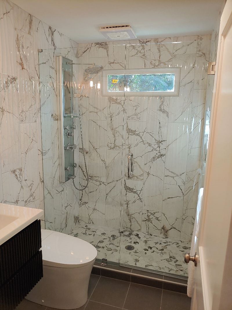 Luxurious spa shower with heated tile floors. Japanese style bidet commode. 