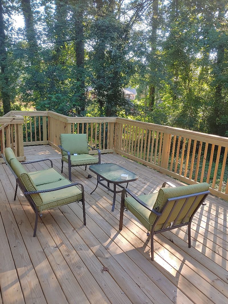 Large rear deck surrounded by acres of trees and privacy.