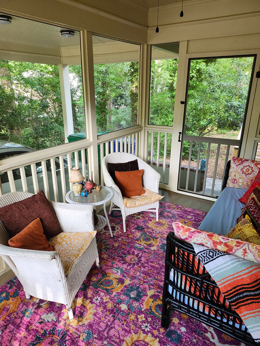 Eclectic screened porch in the Maximalist style, designed for your relaxation