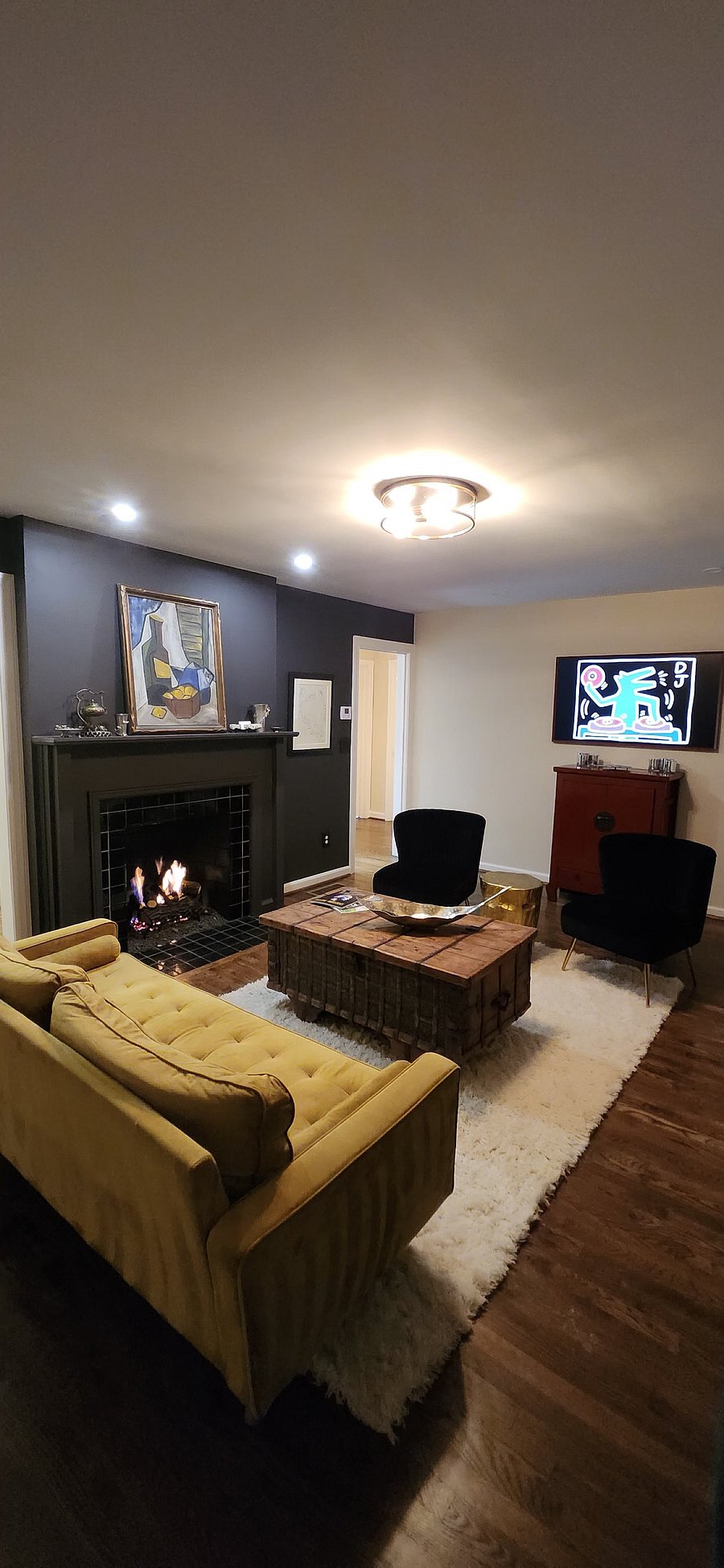Tastefully appointed living room with Frame TV, soundbar and subwoofer. Voice activated speakers for streaming music throughout the home. 
