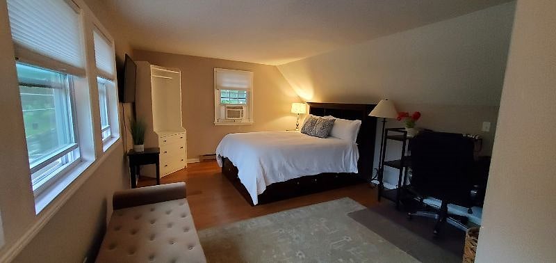 Bedroom on 2nd floor with desk/chair and half bath.