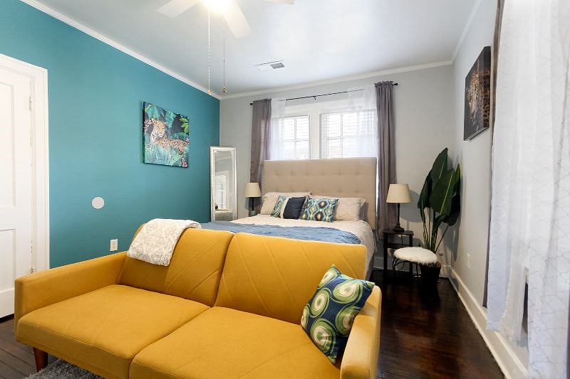 Secondary bedroom featuring beautiful accent wall and colors