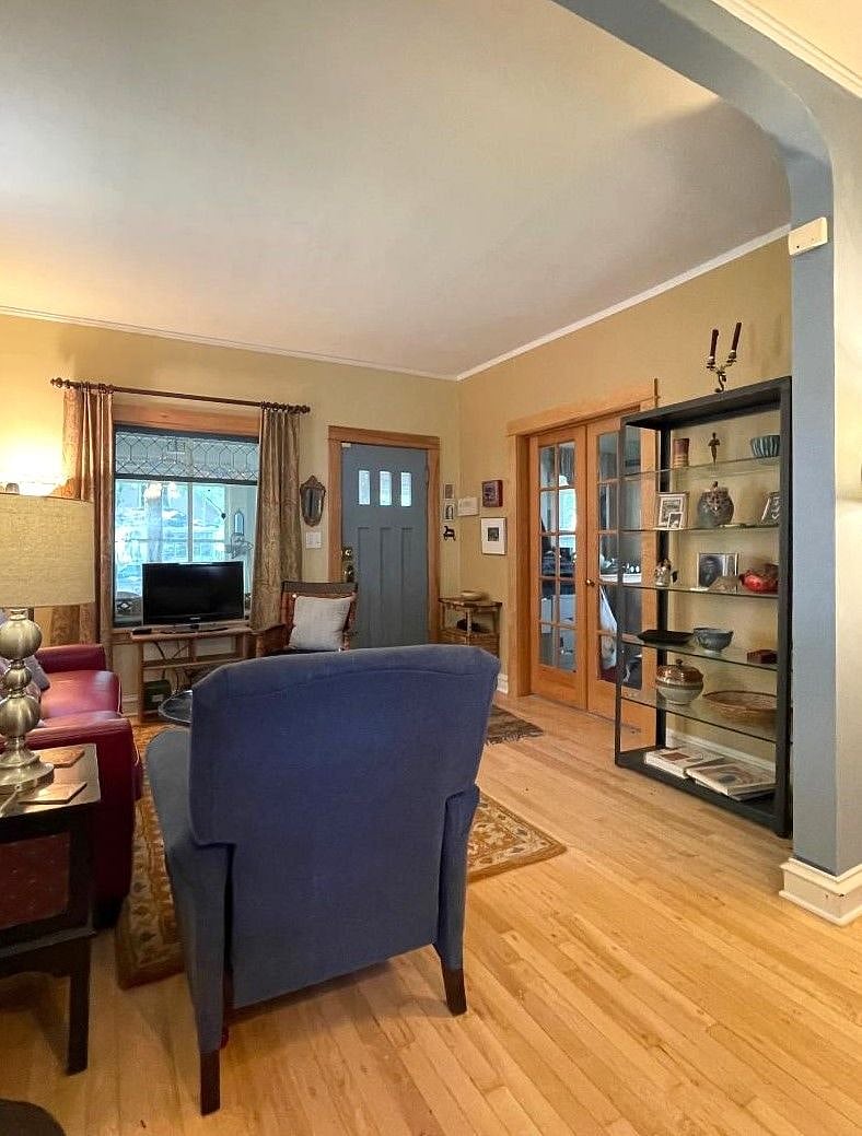 living room: Maple floors, view to laundry/office and front porch. I will remove knick-knacks to make room for your things!