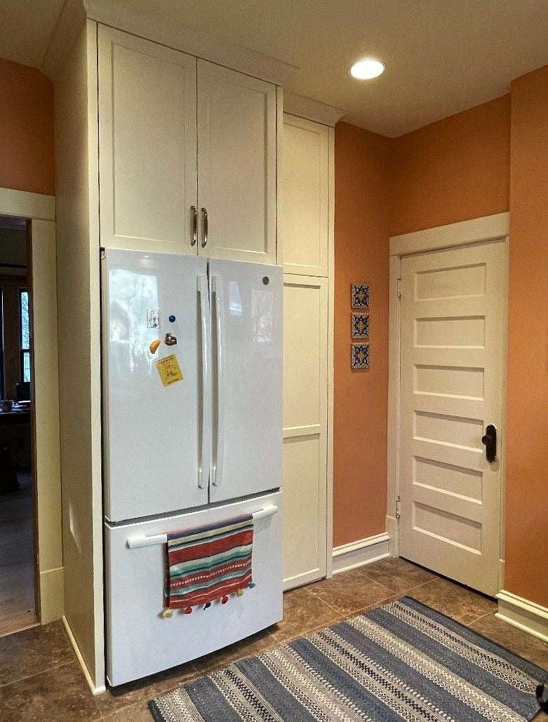 Kitchen: refrigerator and pantry, door to basement. Recycling is in the pantry.