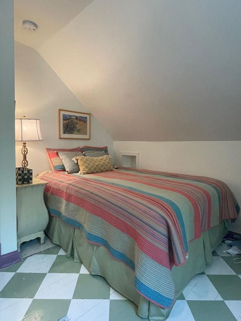 Front bedroom faces west; queen coil/memory foam mattress and boxspring, cell phone cubby, nightstand