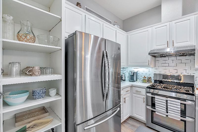 Fully equipped kitchen with cookware, dishware, glassware, pots, and pans. Additional food storage room is available.