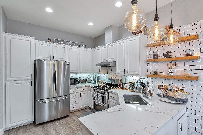 Fully equipped kitchen with overhead range hood, stove, full size kitchen, potware, dishware, silverware, glassware. Stainless steel wide sink with retractable faucet.