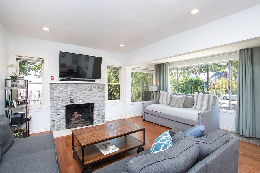 Large living room with TV, fireplace, day bed.