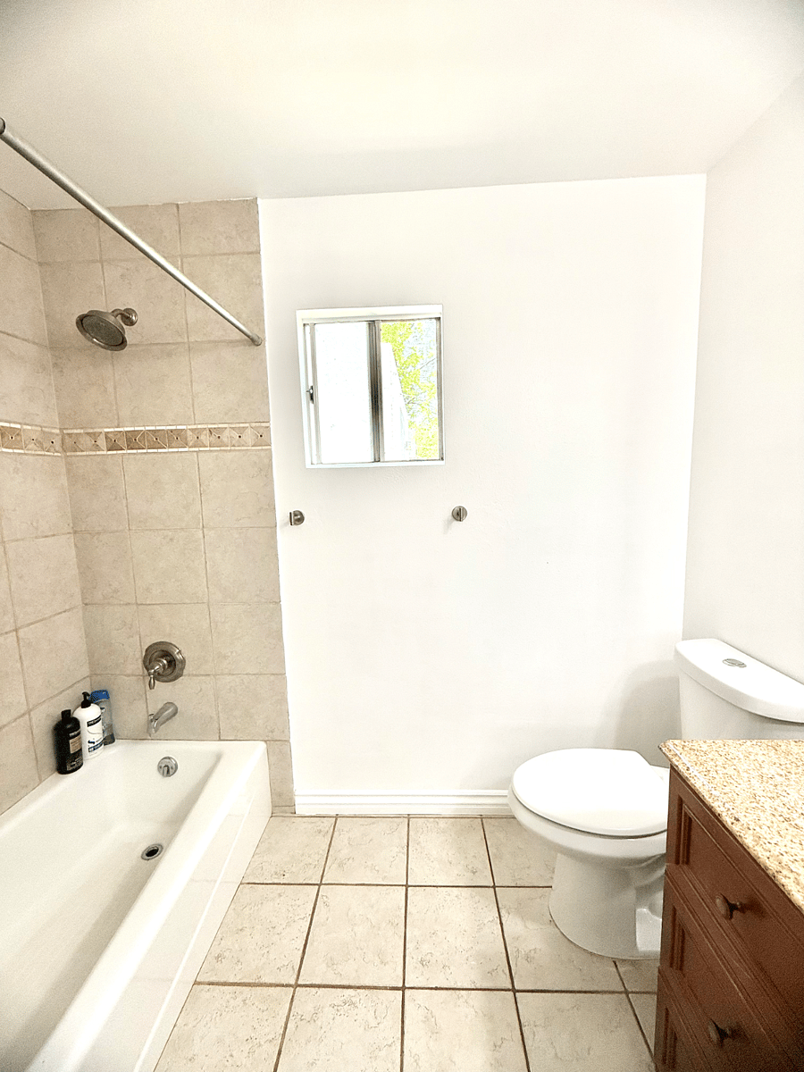 #3 Bathroom: Tub and shower, toilet, sink.
