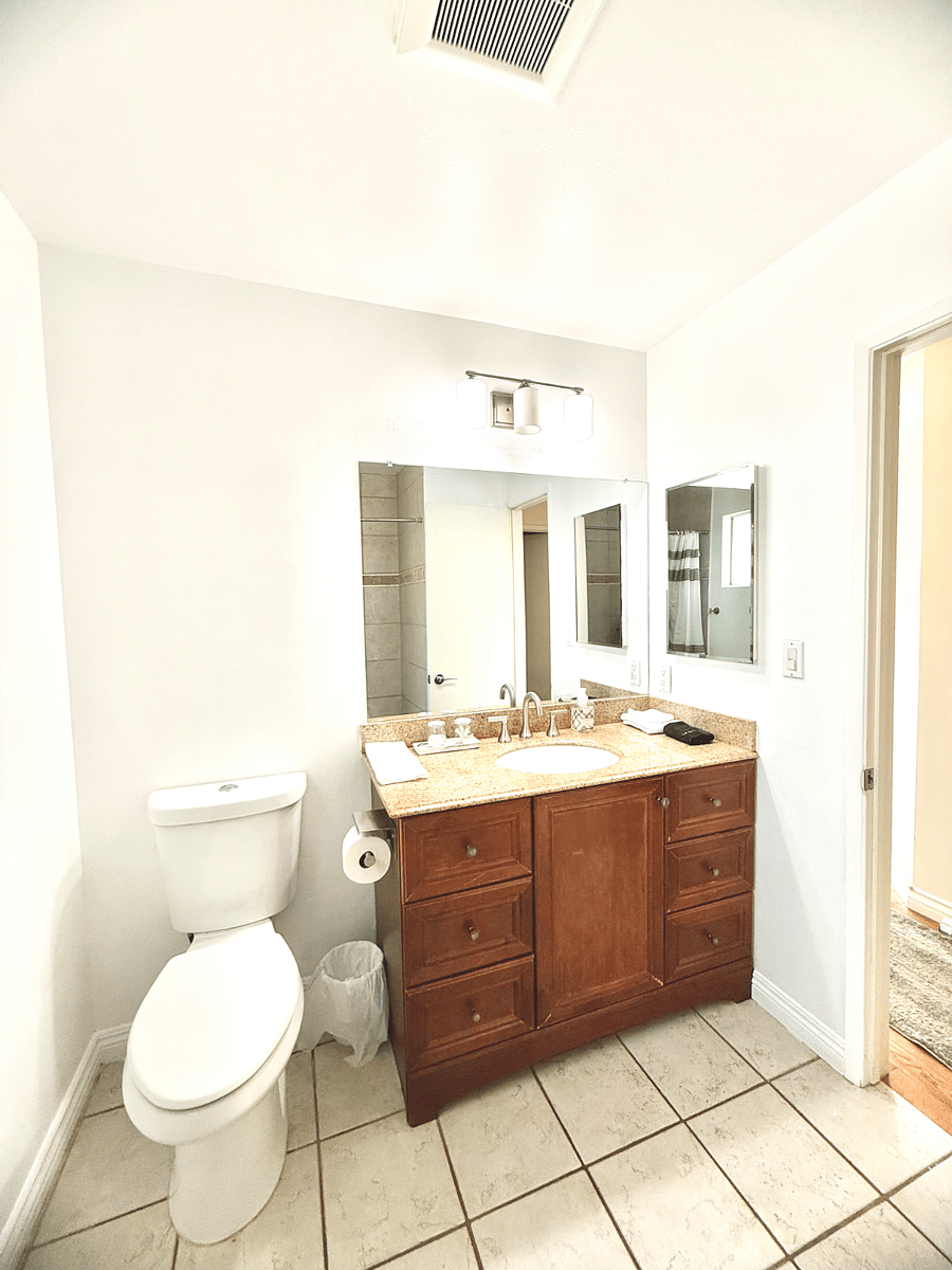 #3 Bathroom: Tub and shower, toilet, sink.