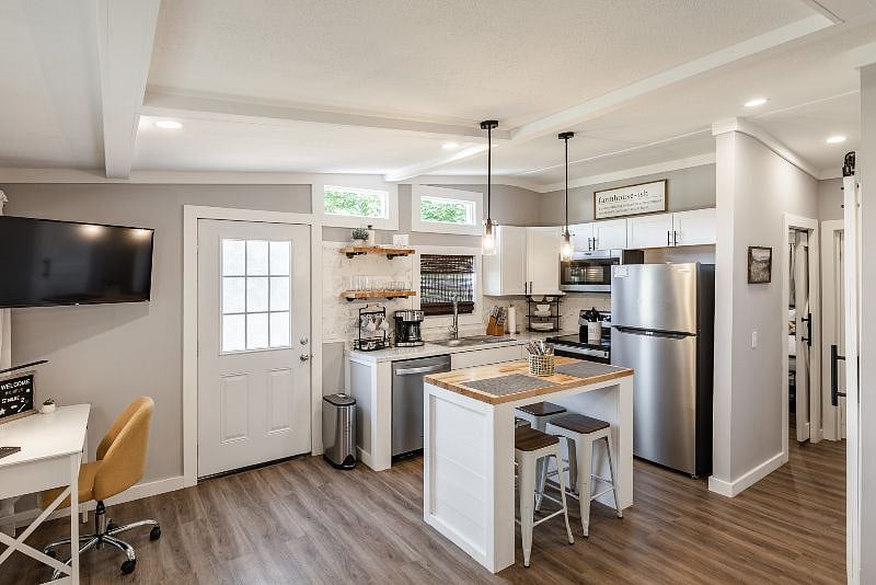 Open floor plan with brand new appliances, a full kitchen and breakfast bar. 