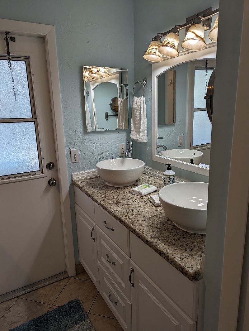 Primary bathroom double sinks, pool access