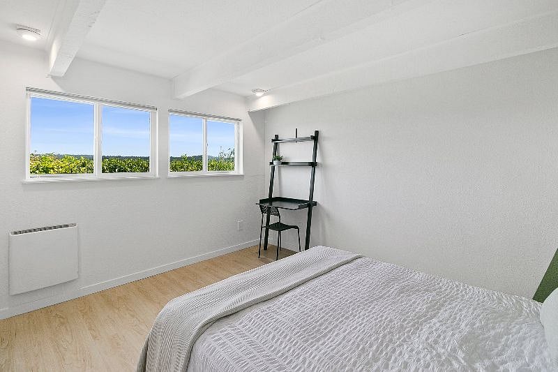 Bedroom windows equipped with blackout blinds. (Not pictured: dresser for additional clothing storage)