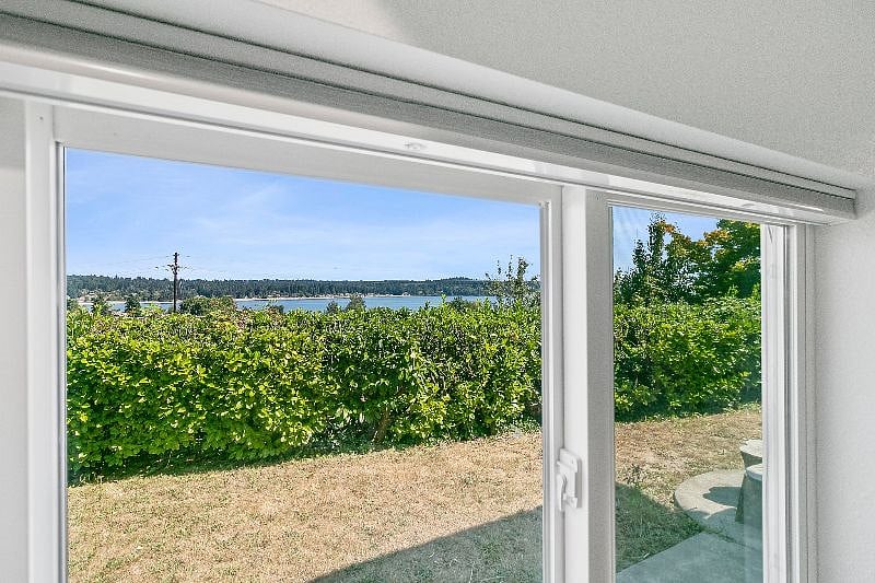 Views of Dyes Inlet from bedroom window. Windows feature blackout shades for peaceful sleep