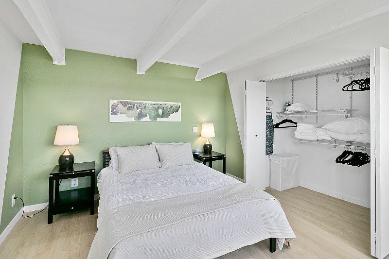 Bedroom with blackout blinds and ample storage space