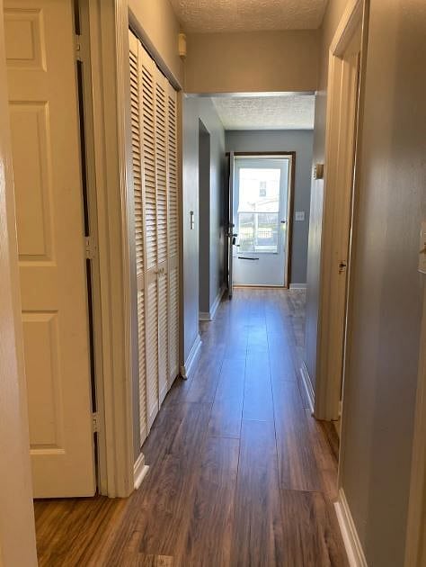 Hallway view looking from the secondary bedroom towards the front of the unit.