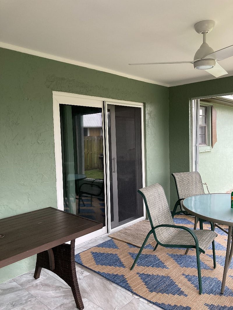 Entrance into seating area and kitchen from screened patio.