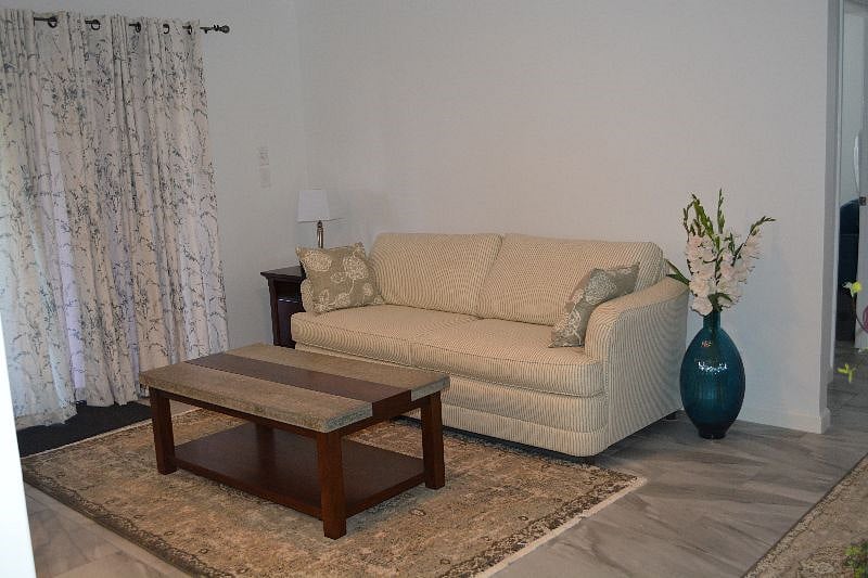 Seating area and breakfast bar, adjacent to the kitchen and patio entrance.