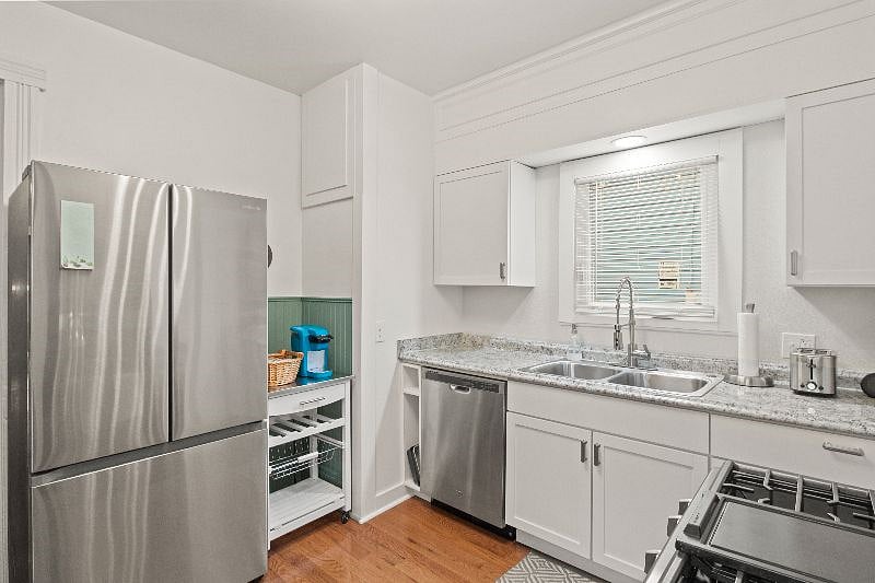 Kitchen view featuring brand new stainless steel Samsung refrigerator and dishwasher