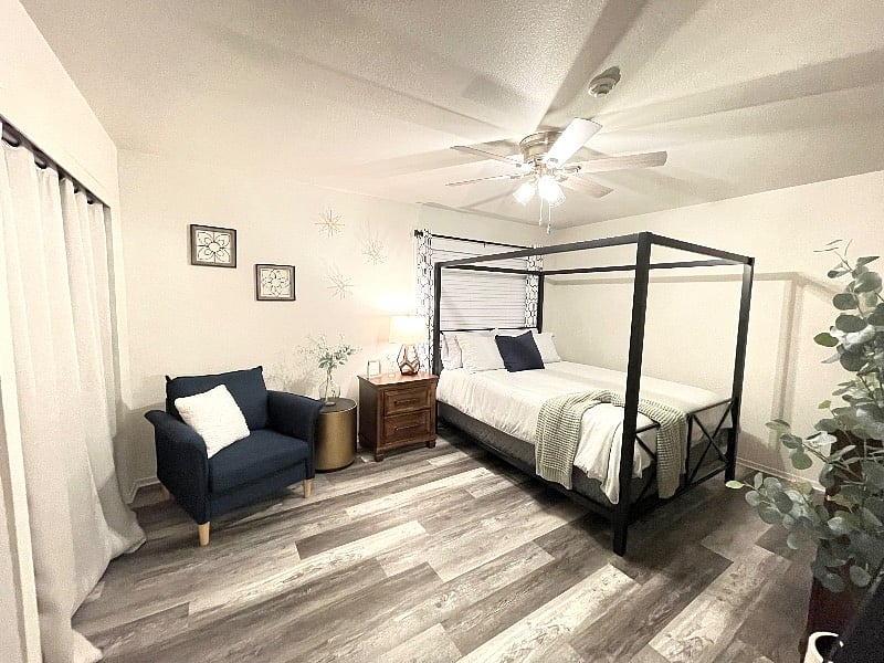 This is your beautiful master bedroom, with very comfortable mattress, beautiful dressing chair, full size Ashely dresser, nightstand with power ports, 14' of closet space, and a full size dressing mirror.
