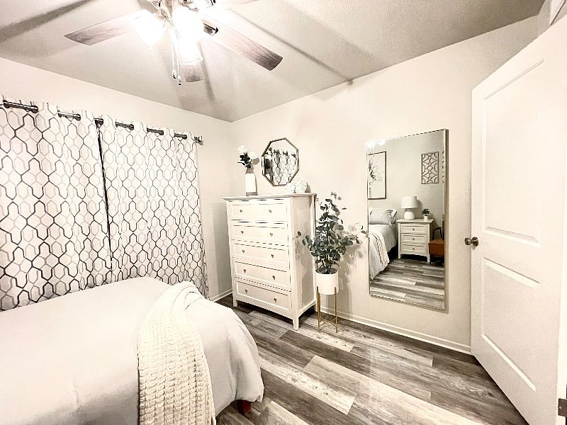 Your beautiful front bedroom with a super comfortable mattress, and comfortable dressing chair, full dresser, and full size dressing mirror.
