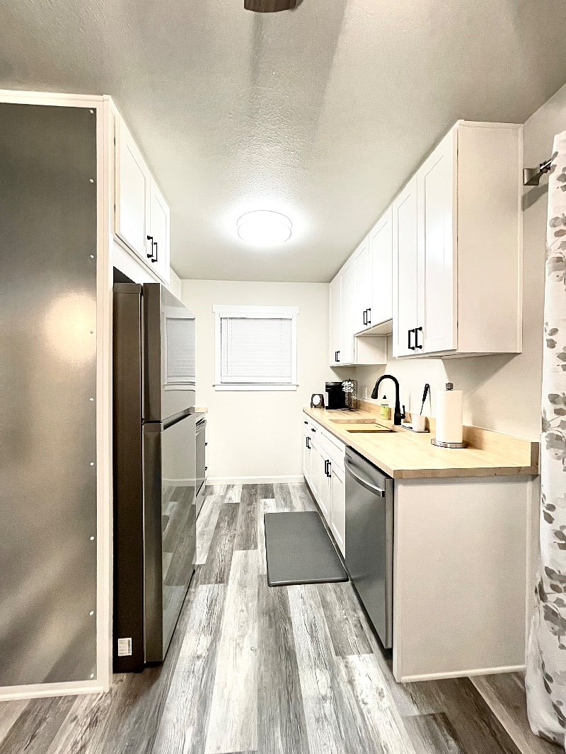 You have a beautiful kitchen wit all stainless steel appliances, touchless faucet, sink with integrated cutting board and drying wrack, and dishwasher.