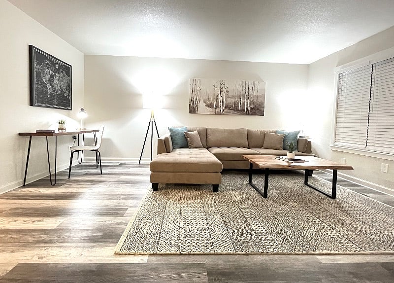 Your beautiful living room with a comfortable Ashley couch with build in chase lounge. You also have a little desk if needed.