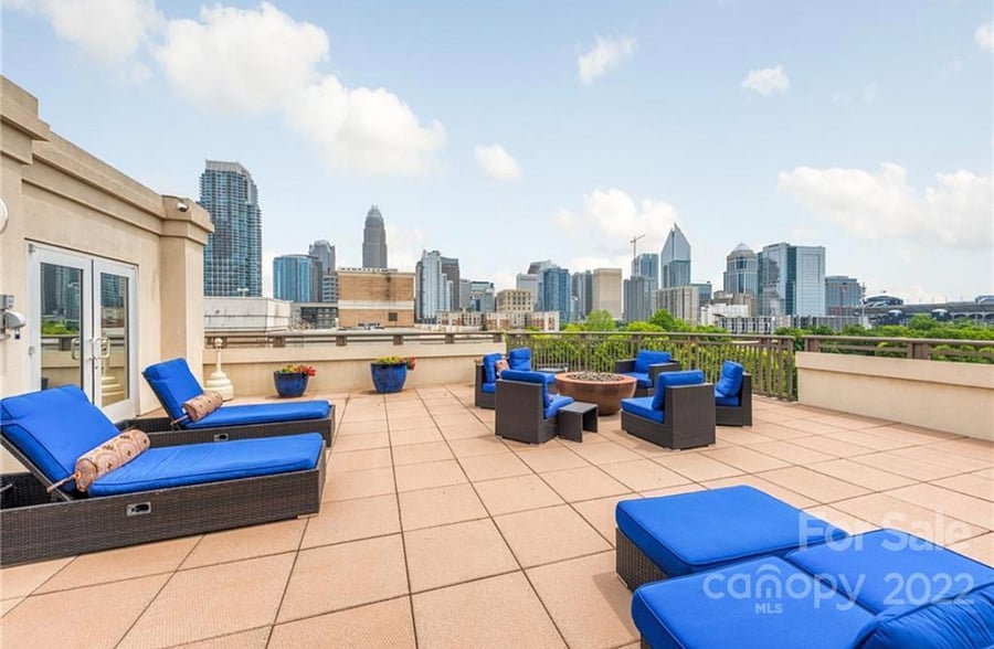 rooftop views during the day with a grill area and chairs