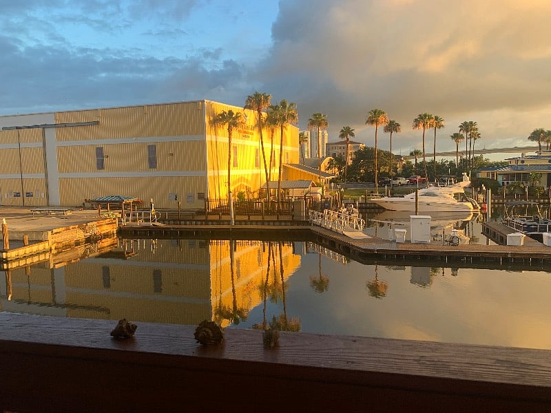 This is sunrise, the sun begins to wake up the marina, do you see the million dollar yacht?
